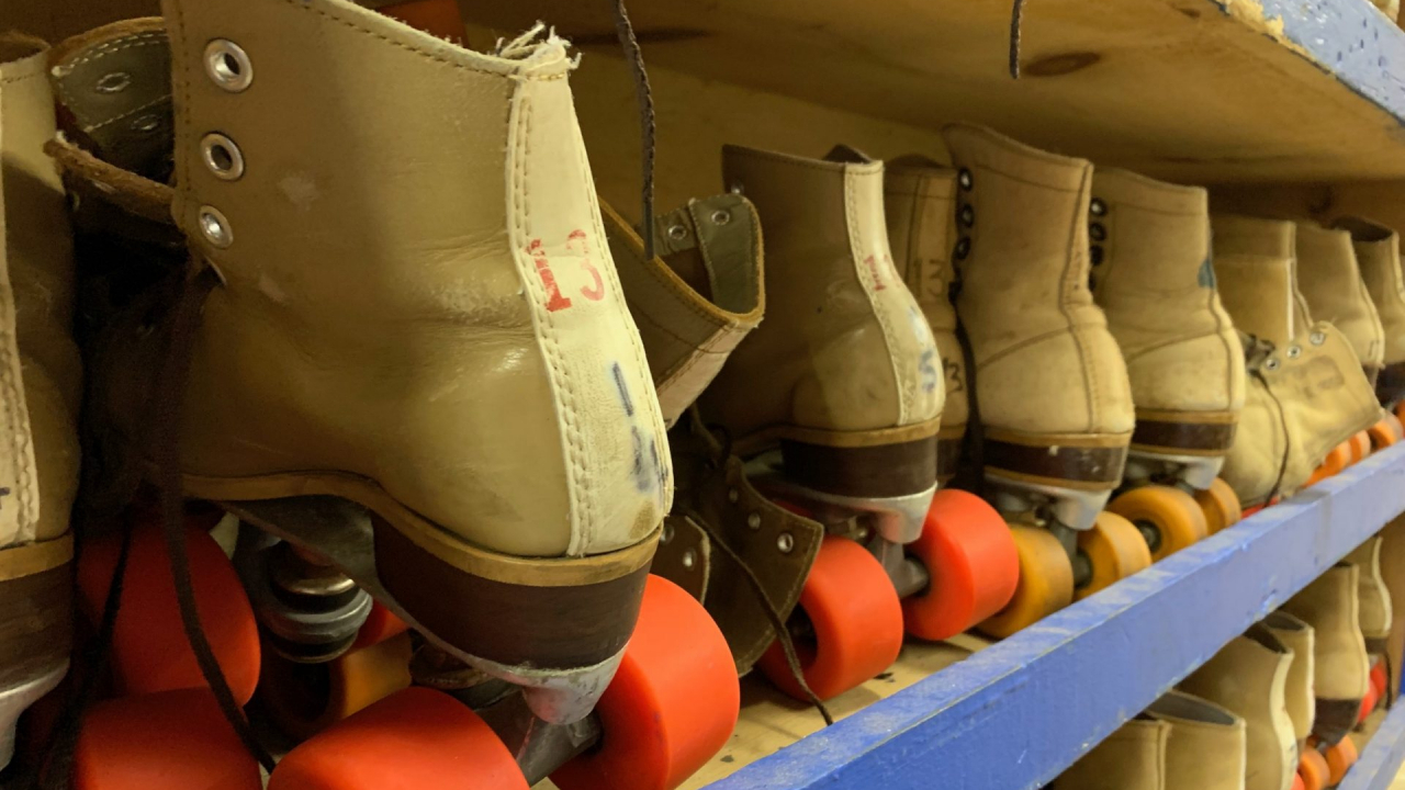 Roller skates lined up on a cart for the next scheduled event.