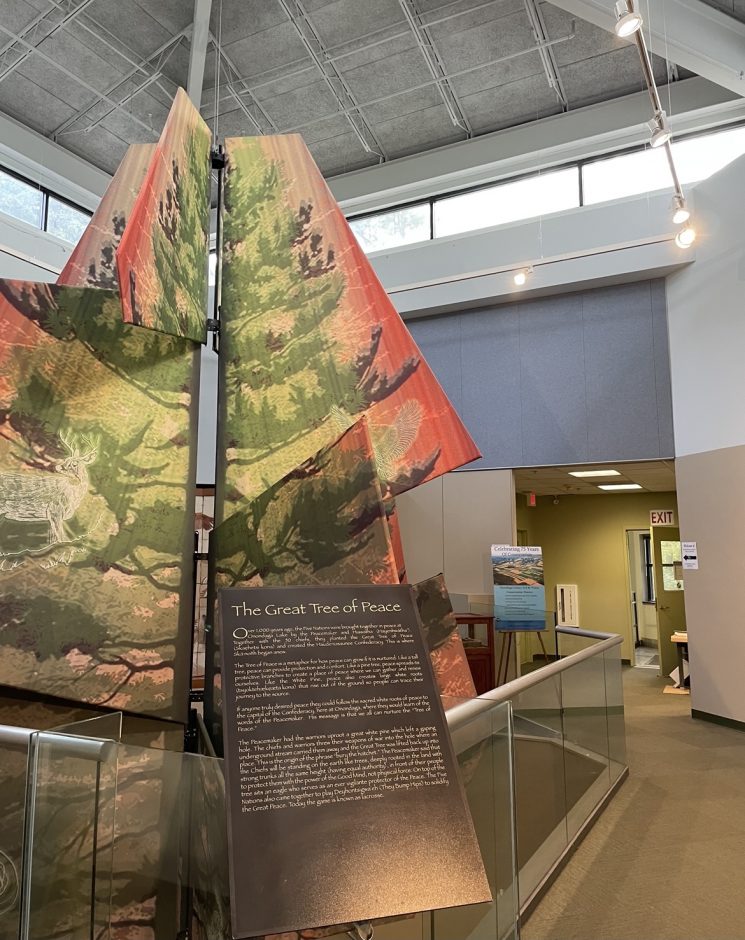 Interlocking fabric pieces that are hung up and displayed in a fashion that resembles a tree. This represents the Great Tree of Peace in the Skä•noñh Great Law of Peace Center on Onondaga Lake.