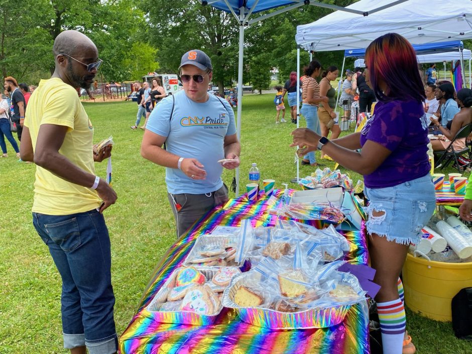 Two people looking at cookies made by one of the vendors at Soul of Pride Cookout.