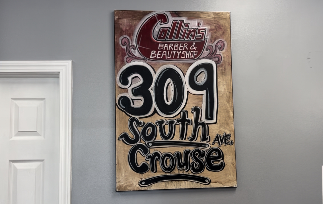 Sign of the original Collins Barbershop Address at their new shop location on Erie Boulevard