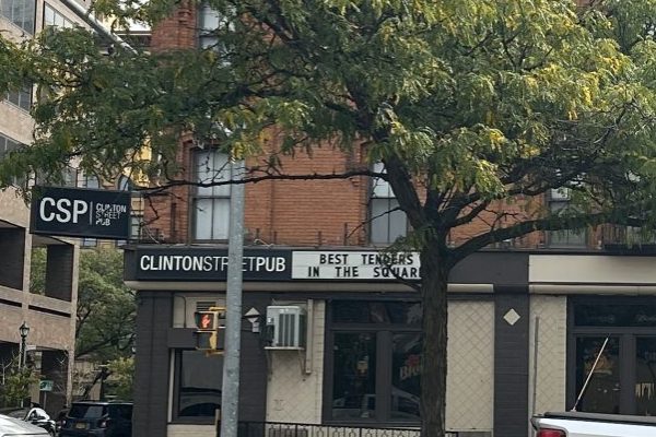Exterior of Clinton Street Pub with a tree downtown.