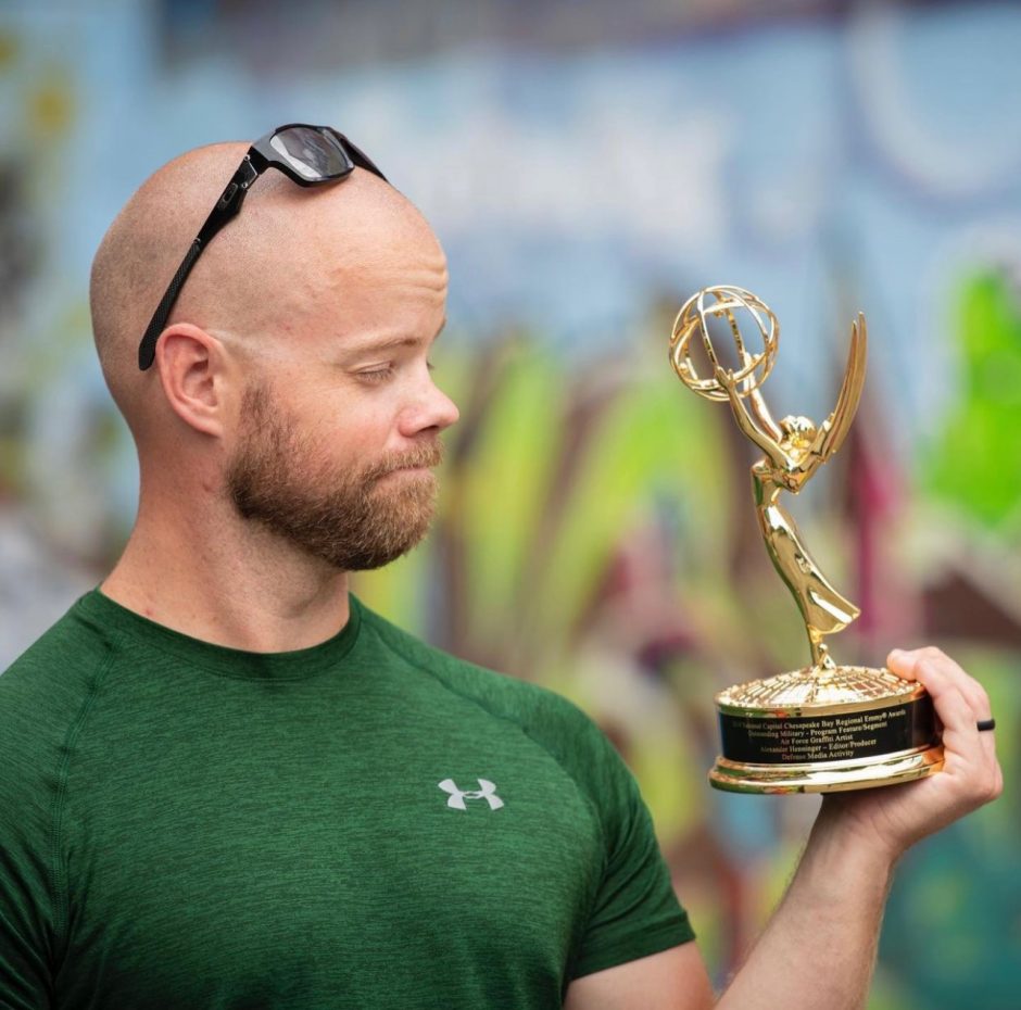 Military Journalism Student, Alex Henninger, holds his first Emmy Award