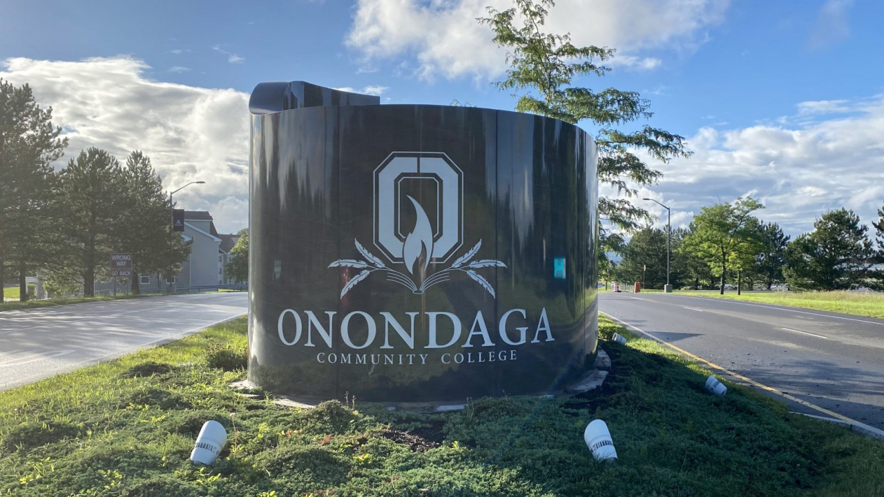 The entrance to Onondaga Community College is marked by a large stone banner (pictured above).
