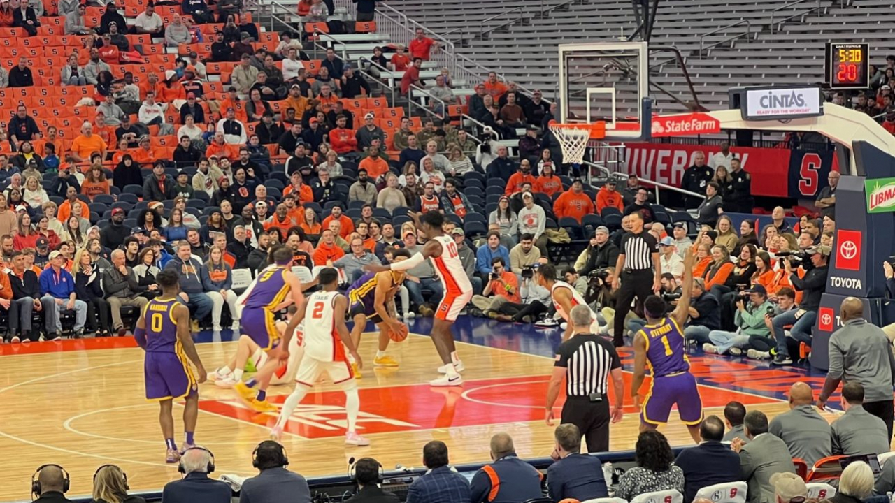 Syracuse Orange Center Naheem McCloud (10) guarding LSU Forward Jalen Reed (13) as he faces the basket from the left midrange corner.
