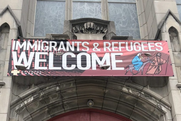 Sign outside University United Methodist Church welcoming refugees.