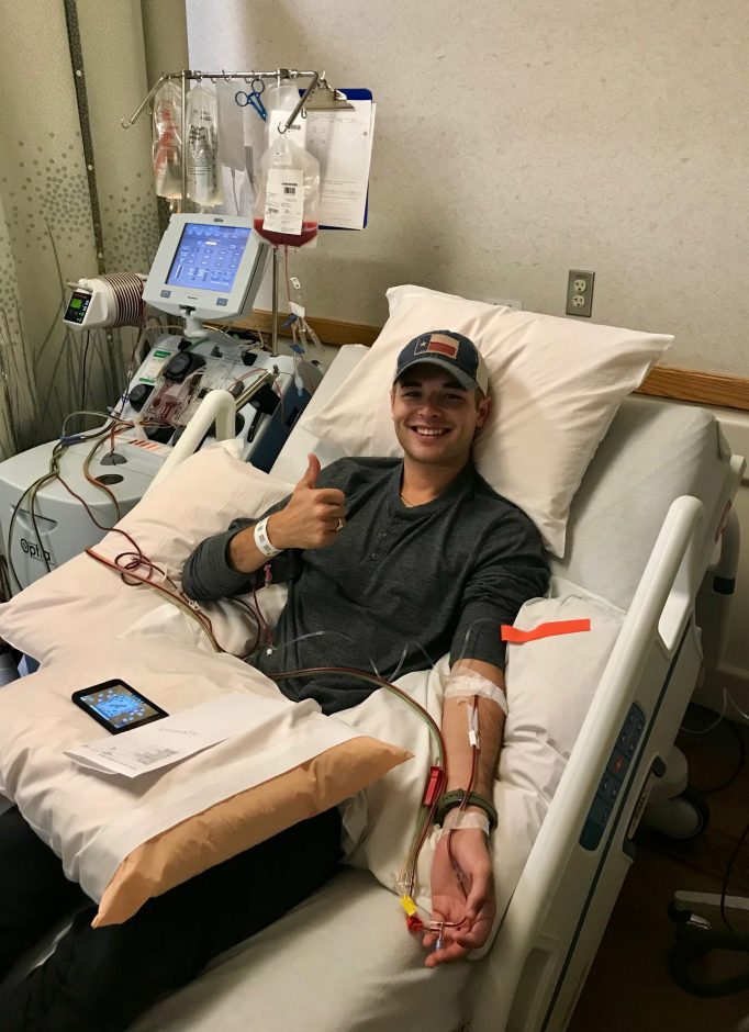 Hunter Sáenz sitting in hospital bed with an IV and needle in his arm donating his bone marrow