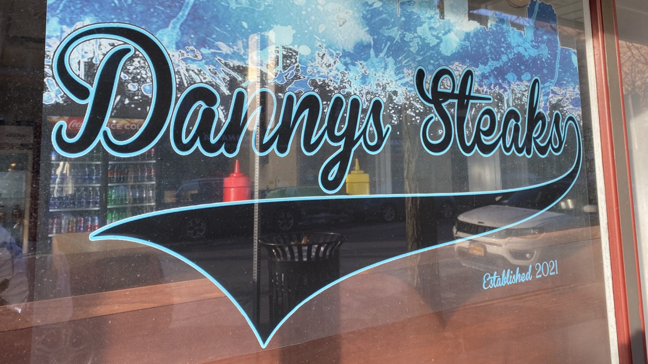 A picture of the Danny's Steaks sign on the exterior of the building