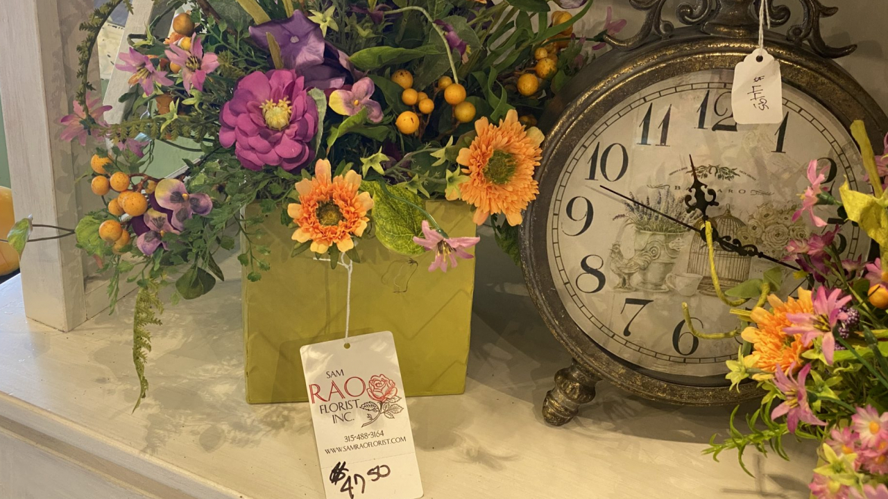A Spring display, featuring a branded price tag and a clock