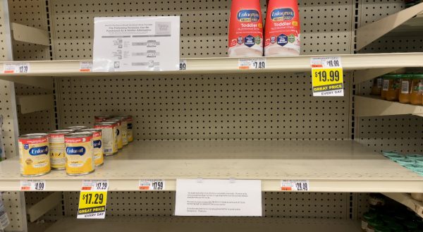 A close-to empty aisle of baby formula inside Tops market.
