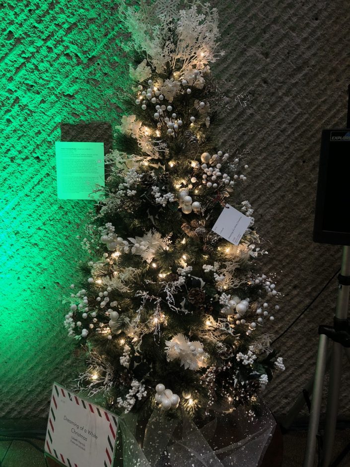 Tree with white ornaments, ribbon, and garland