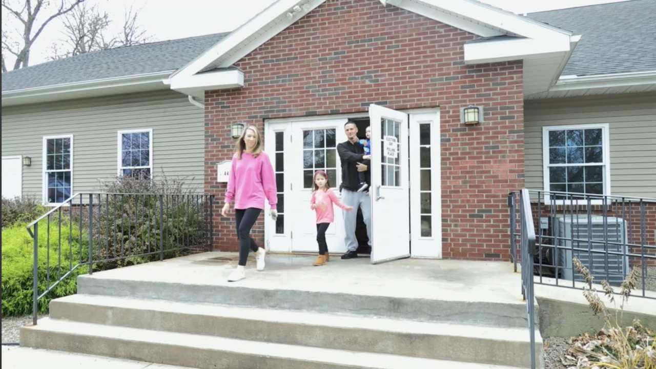 The Sidnik family coming out of the poll site with after casting their ballots on Election Day in Syracuse.