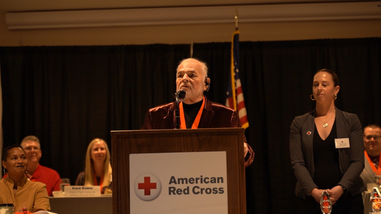Jan Maloff gives a speech after receiving the Community Impact Hero Award from the American Red Cross at the Mariott Syracuse Downtown on Dec. 7, 2022. Maloff has been refurbishing bikes and giving them back to the community for the past 25 years and was nominated for the award.