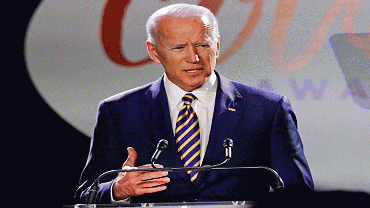 Joe Biden stands at a podium while delivering a speech at the Courage Awards 2019.