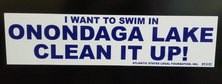 A bumper stick reading, "I want to swim in Onondaga Lake clean it up!" on a cabinet in the office of Travis Glazier, who is the Director of the Onondaga County Office of the Environment. Preliminary results of an online survey show almost 32,000 people are willing to swim in the lake.