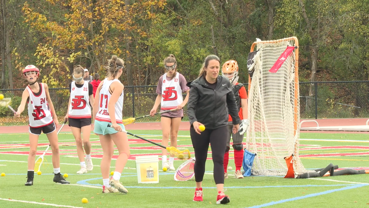 Head Coach Tracy Parker collects lacrosse balls with her Jamesville-DeWitt High School girls' lacrosse team on Saturday, Oct. 29 at 9:30 a.m. in Syracuse, N.Y.