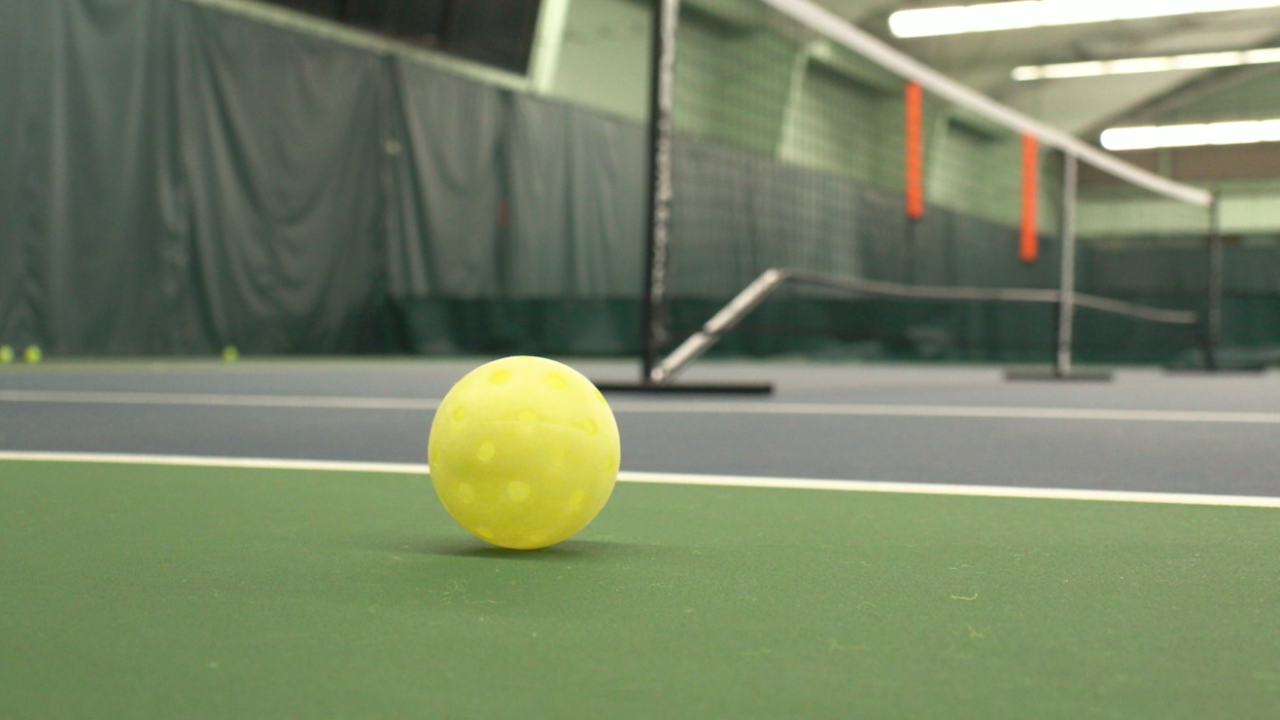 A pickleball sits on an indoor court at the Elevate Fitness in Liverpool, New York.