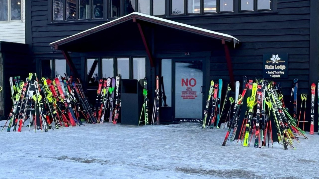 Skis lined up on a lodge before a ski race.