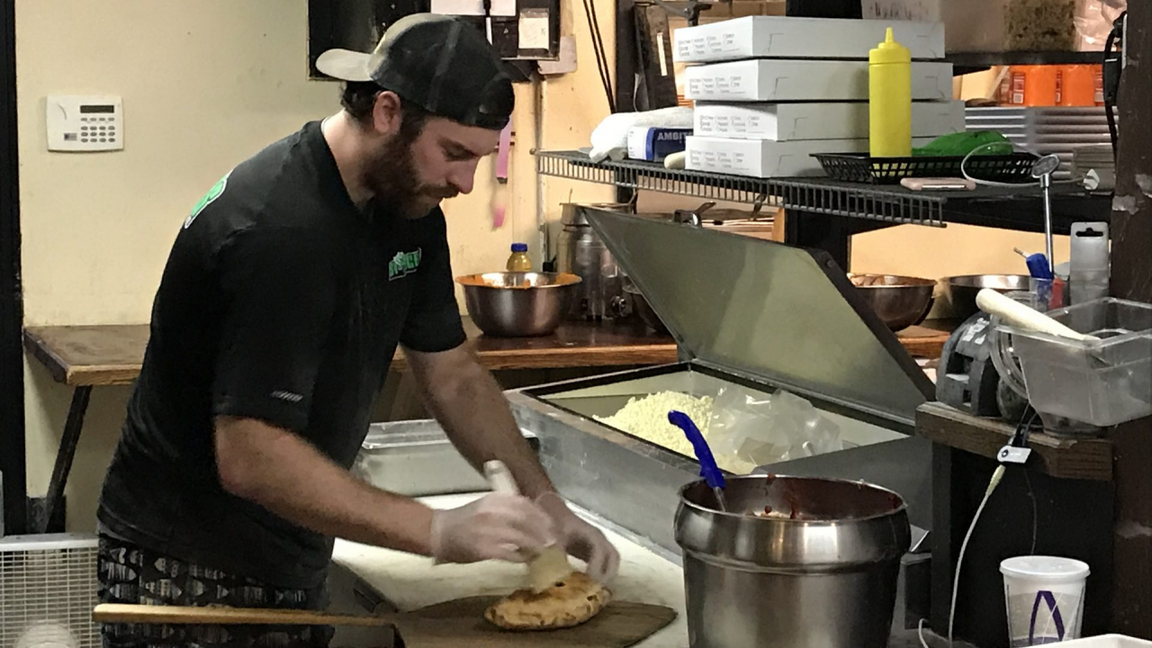 A chef at Stingers Pizza Pub prepares a calzone in the Kitchen