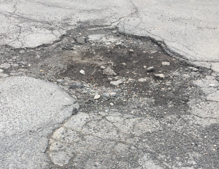 A pothole sits in the middle of the road in Syracuse.