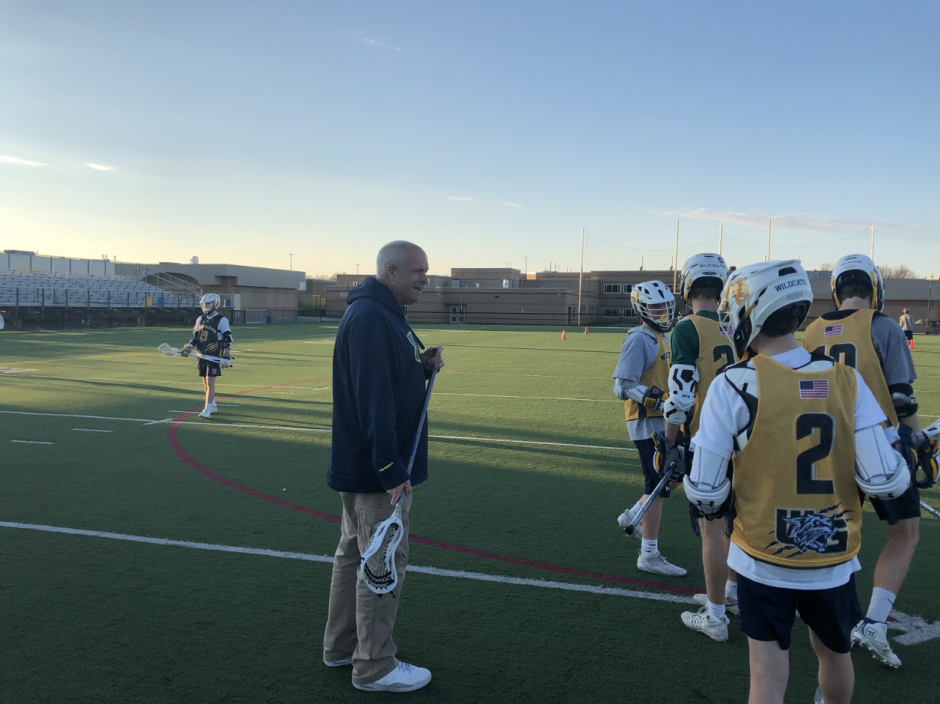 West Genesse Lacrosse Head Coach Sean Smith jokes around with his players during practice.