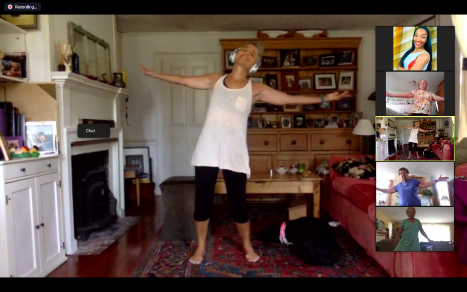 woman stretching on group call with participants mirroring.