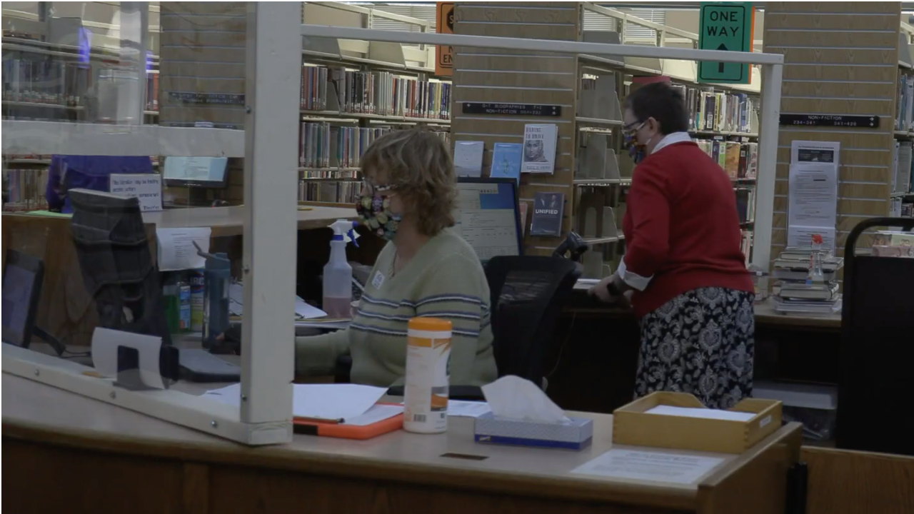 Nancy Howe (left) and Jacquie Owens working the desk at Baldwinsville Public Library