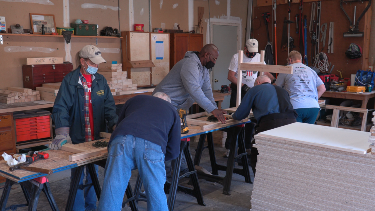 A group of volunteers working together to build desk
