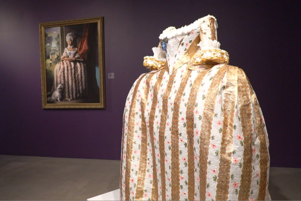 A painting and hand-painted dress featured in Fabiola Jean-Louis's Rewriting History Exhibit at the Point of Contact Gallery in downtown Syracuse.