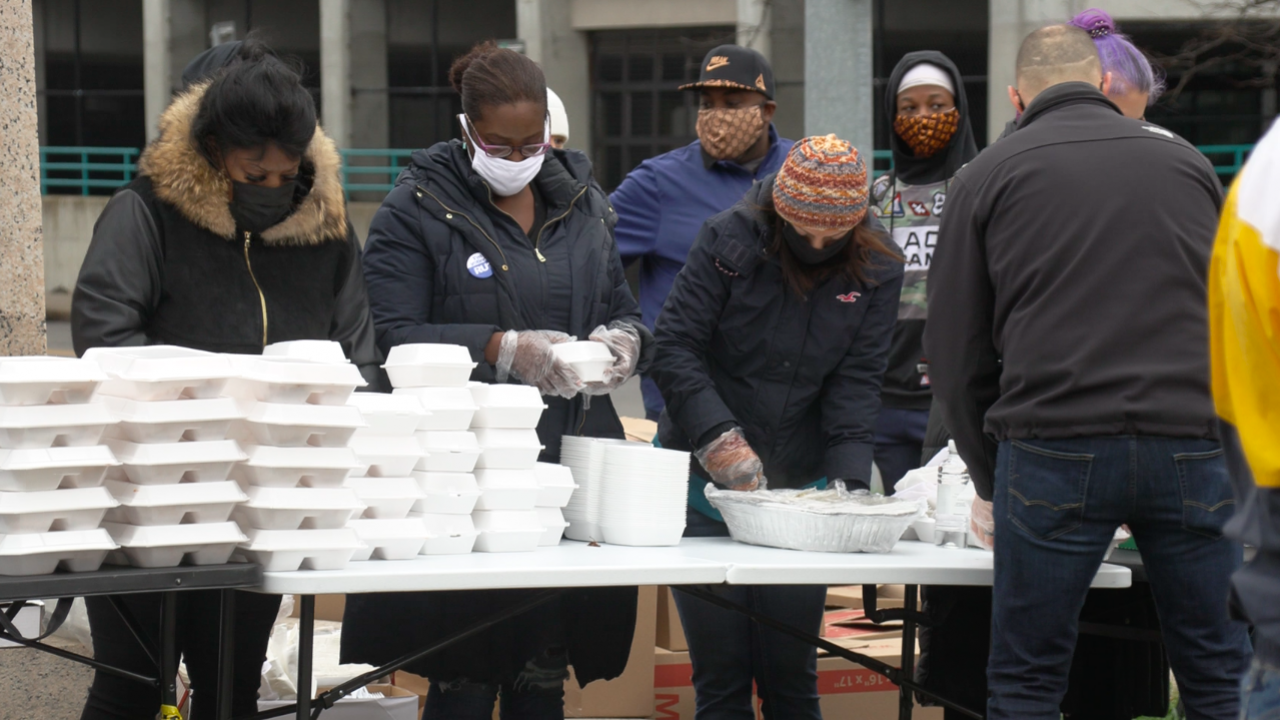Volunteers preparing meals to distribute at Billings Park.