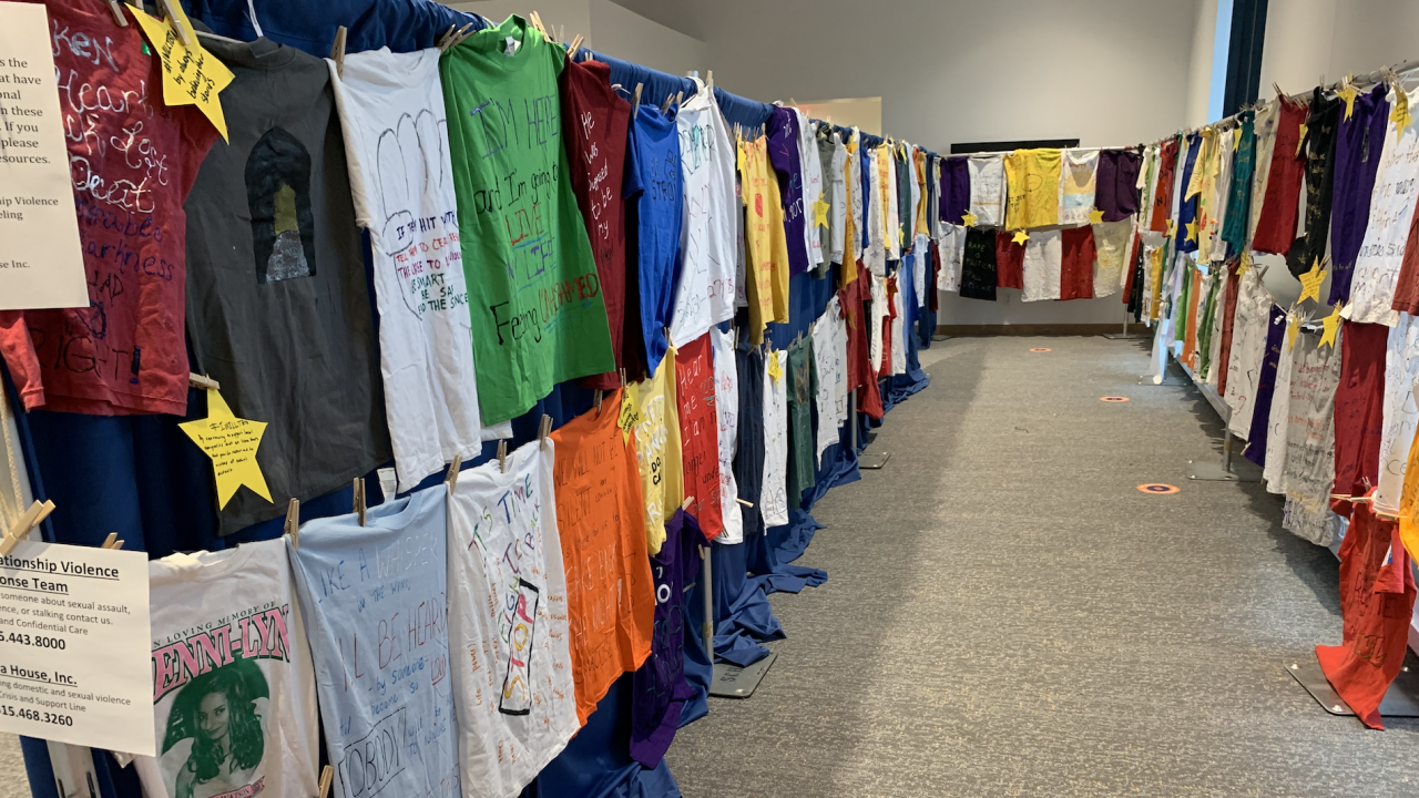 A display of t-shirts in the Schine Center made by people who wanted to express their feelings or experiences with sexual or domestic violence by writing about it on the shirts.