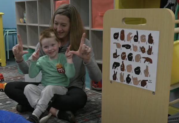 Mom and son teaching American Sign Language