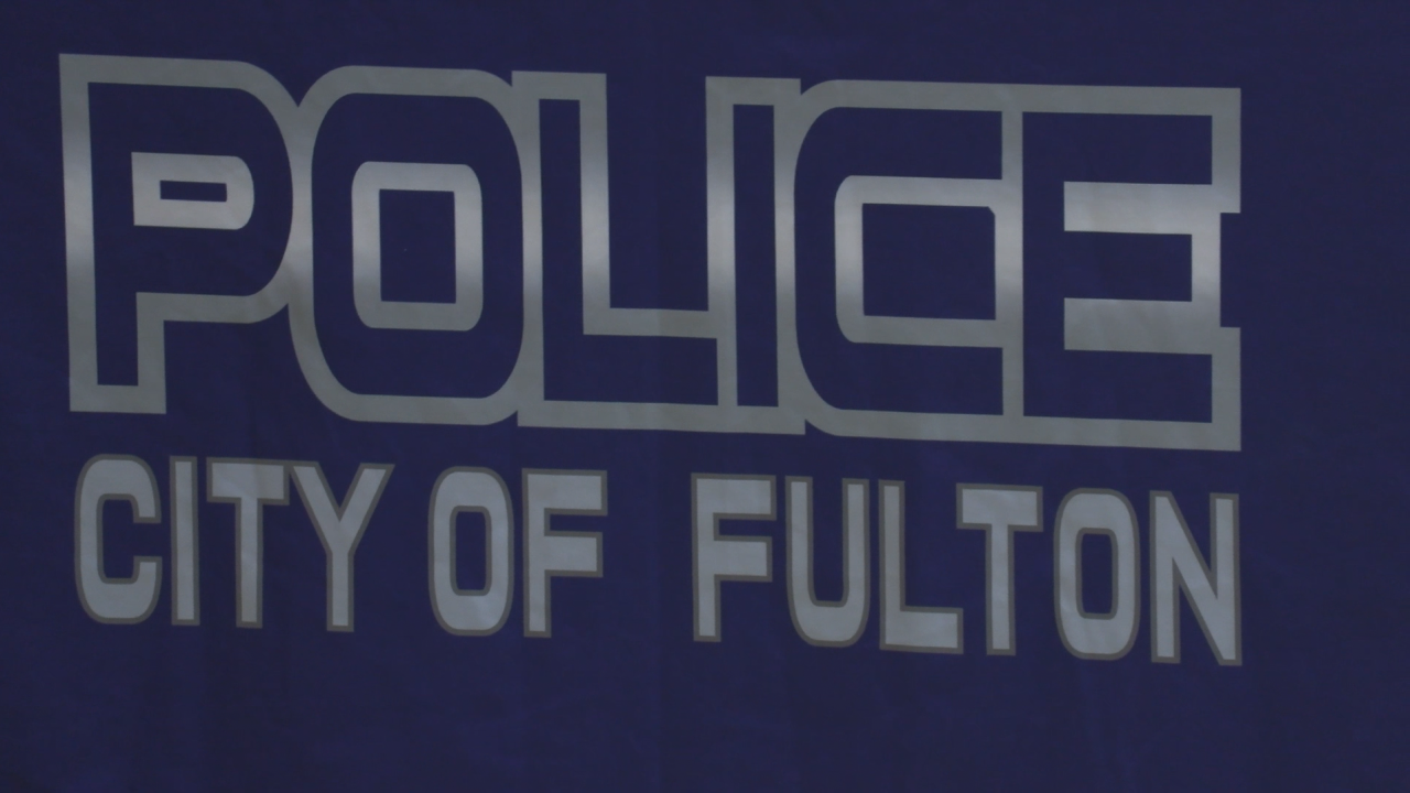 Silver text on a deep blue field "Police: City of Fulton"