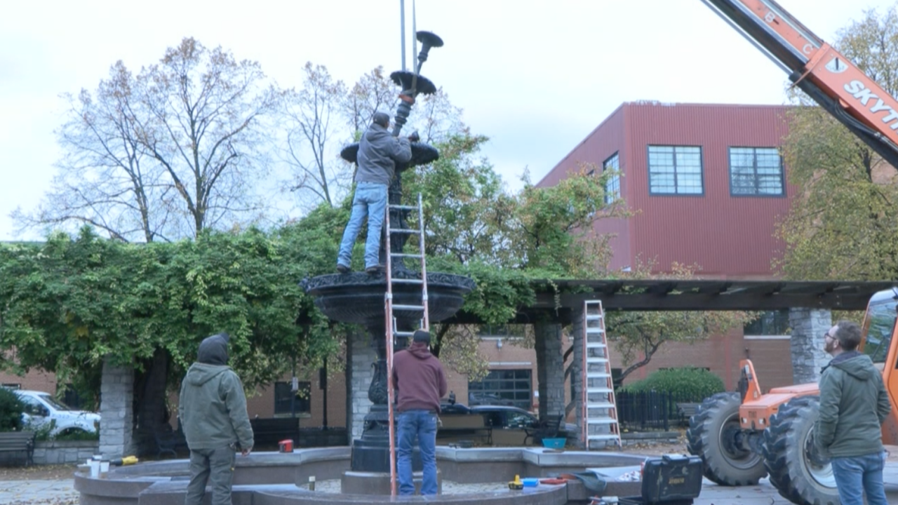 Construction workers disassemble the fountain for it to be shipped out and refurbished.