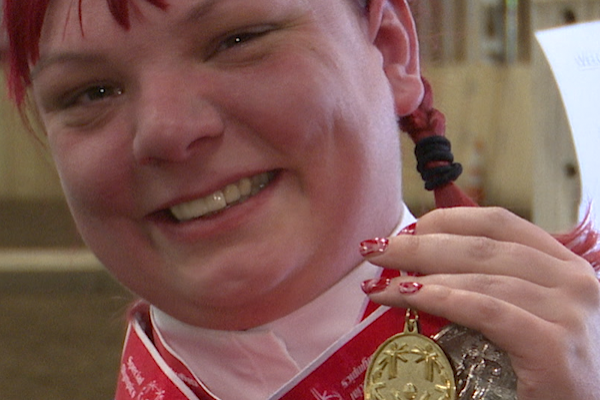 Kinsey Henry Holding Her Medals at NYS Special Olympics Games.