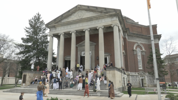 People gather outside Hendricks Chapel at Syracuse University to celebrate Eid al-Fitr.