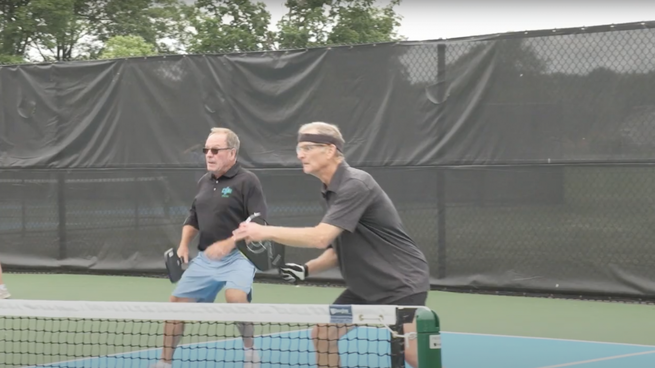 Two men playing pickleball.