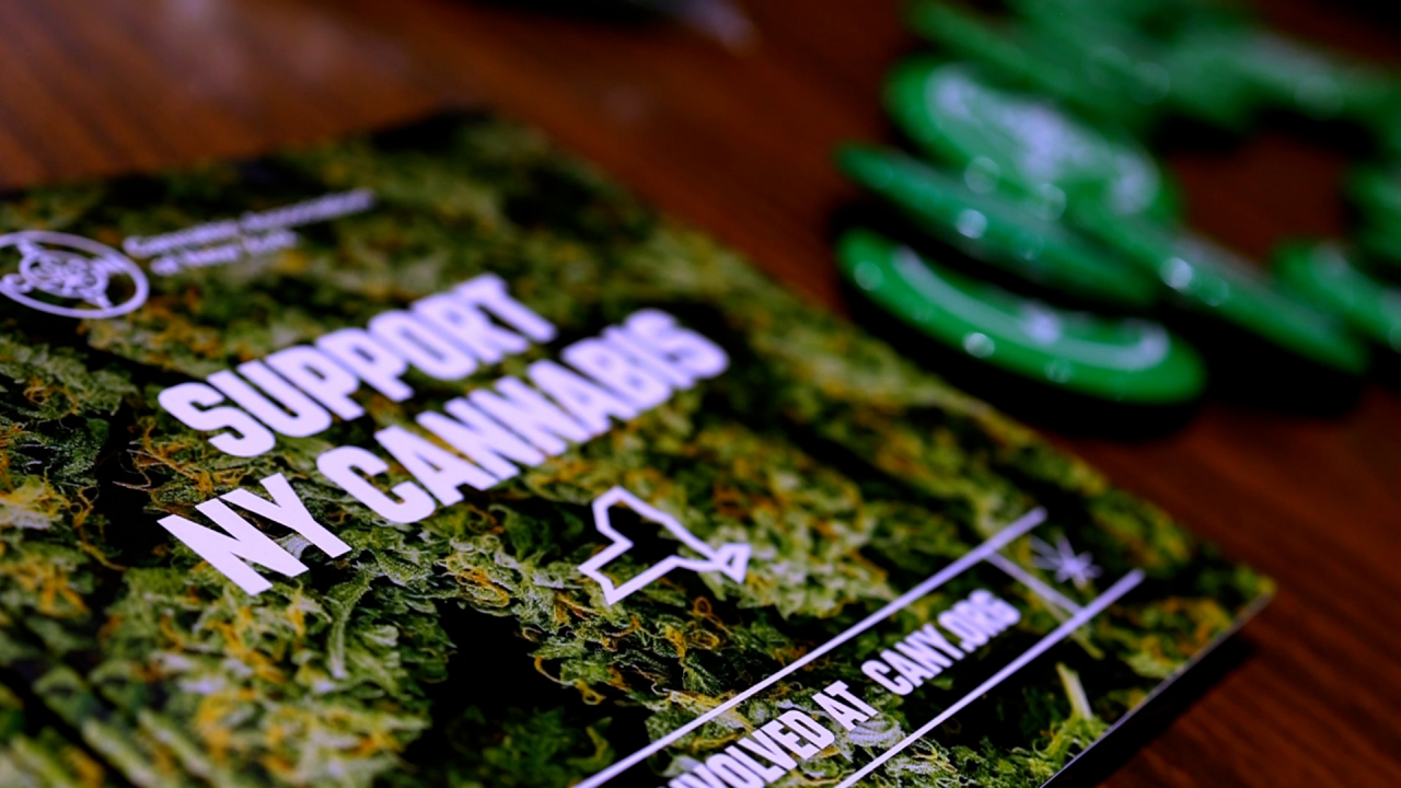 Cannabis Association of New York hands out pamphlets during a Christmas themed potluck in support of marijuana entrepreneurs in Syracuse, NY, on December 8, 2022.