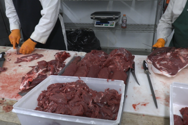 Deer meat being cut up by butchers