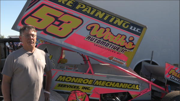 Shawn Donath stands in front of his sprint car while talking to NCC News