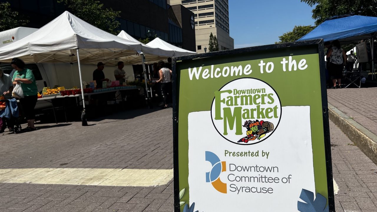A sign welcomes patrons to the Downtown Farmers Market at Clinton Square in Syracuse