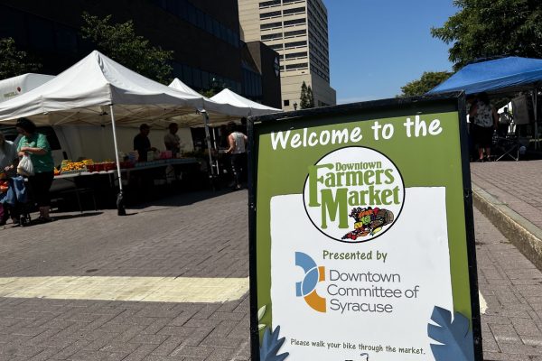 A sign welcomes patrons to the Downtown Farmers Market at Clinton Square in Syracuse