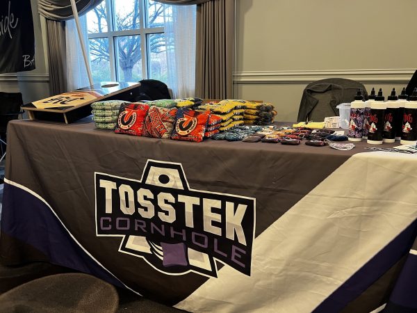 A table for Tosstek Cornhole offers different types of bags for players to throw at the ACL regional tournament.