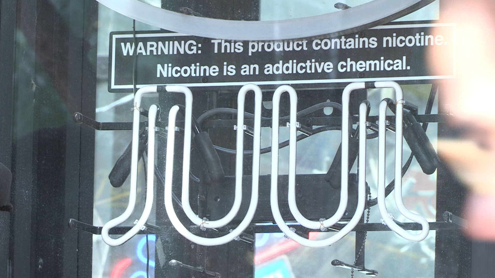 A vape warning sign found in the window of a convenience store on Marshall Street.