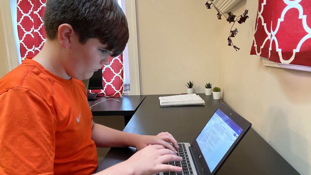 Eighth-Grader Braeden Hennessey working on the computer to complete his remote assignments.