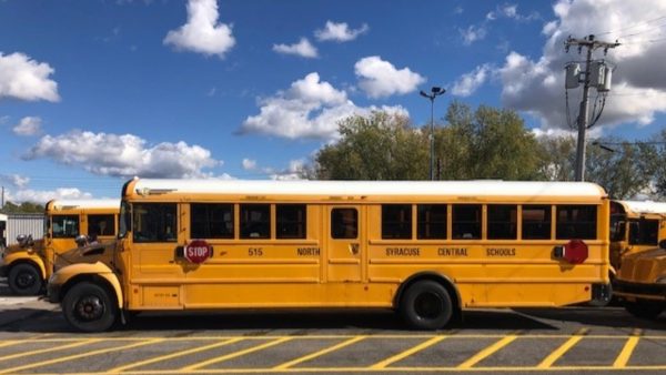 A North Syracuse Central School District bus sits in a parking lot.