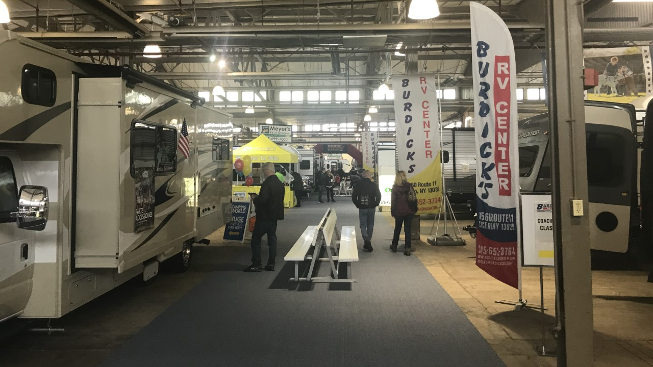 A wide angle picture of the floor of the CNY RV and Camping show filled with different models of RVs.
