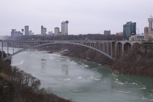 The Rainbow Bridge spans the Niagara River and connects Niagara Falls, N.Y., left, to Niagara Falls, Ontario, Canada. Wednesday, March 18, 2020 as seen from the New York side of the border, when the Canada-U.S. border first closed to non-essential traffic in both directions in an effort to combat COVID-19.