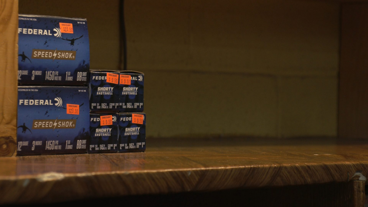 Four boxes of ammunition and an empty shelf.