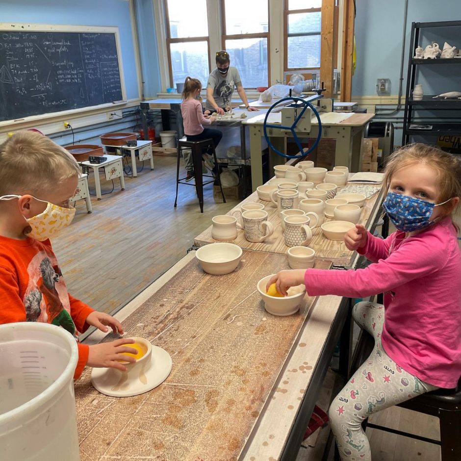 Two children, wearing masks, take part in a ceramics class at 4 Elements Studio now that the studio had re-opened with appropriate COVID protocols in place.