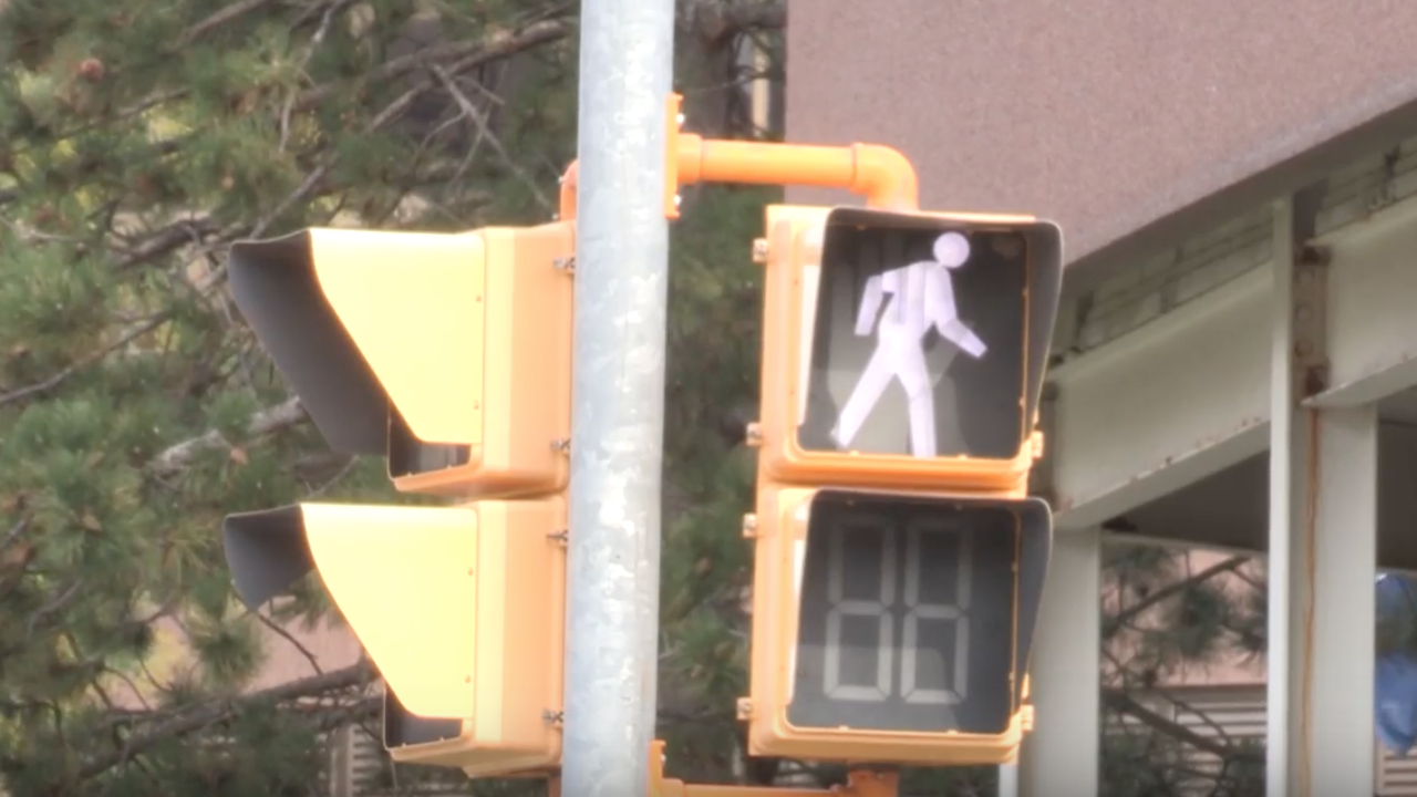 A crosswalk sign indicating it is safe to cross.